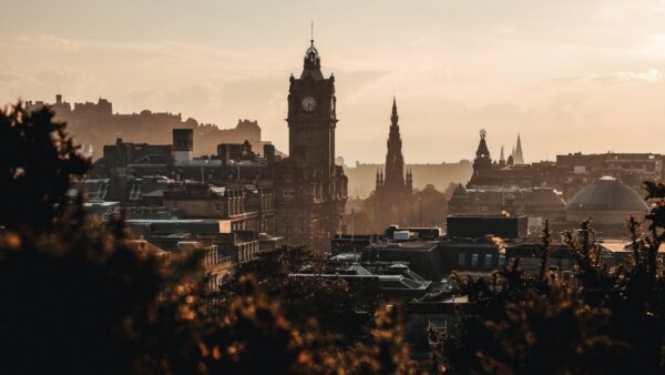Edinburgh skyline at sunset with Edinburgh Castle and the Balmoral Hotel — home of the Edinburgh Fringe Festival